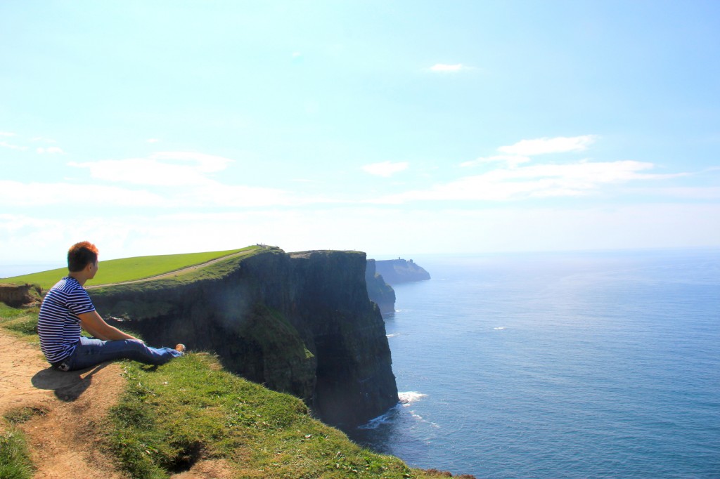 Sitting at the edge of The Cliffs of Moher