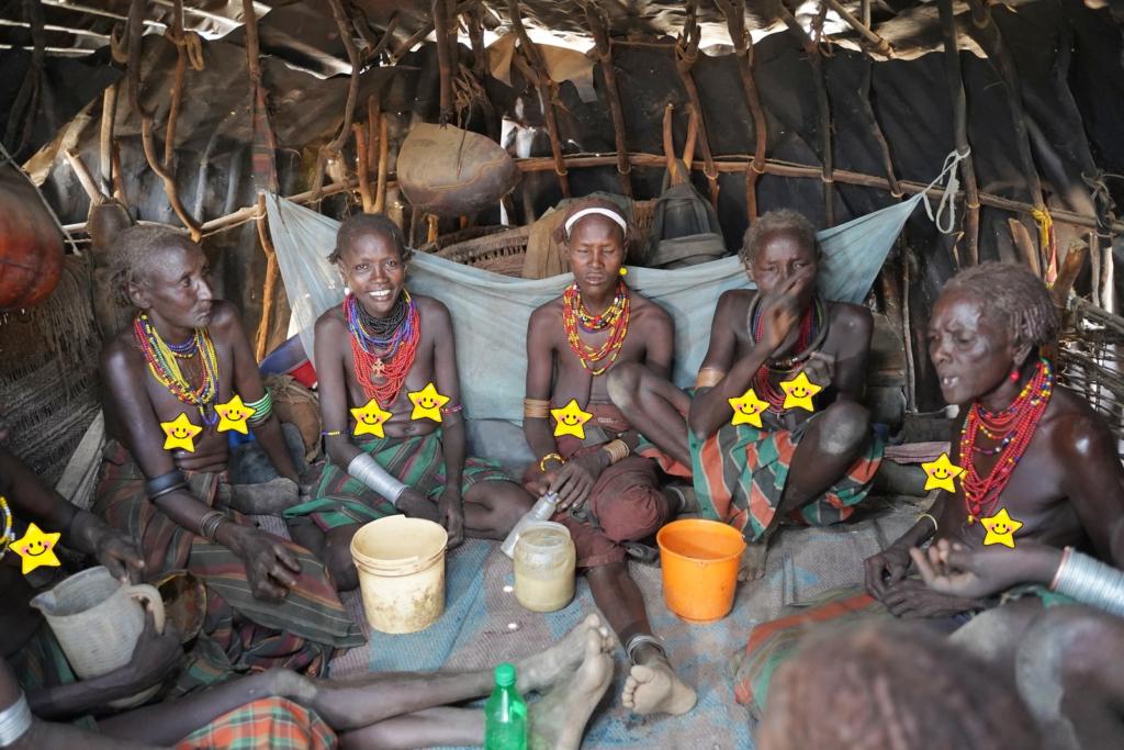 Dassanech women in their huts for celebrating a new born baby